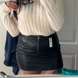 Black skirt with slit and zip up front. Size: L